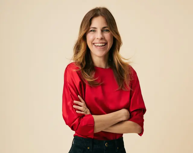 Dr. Robin Berzin in red blouse smiling at camera
